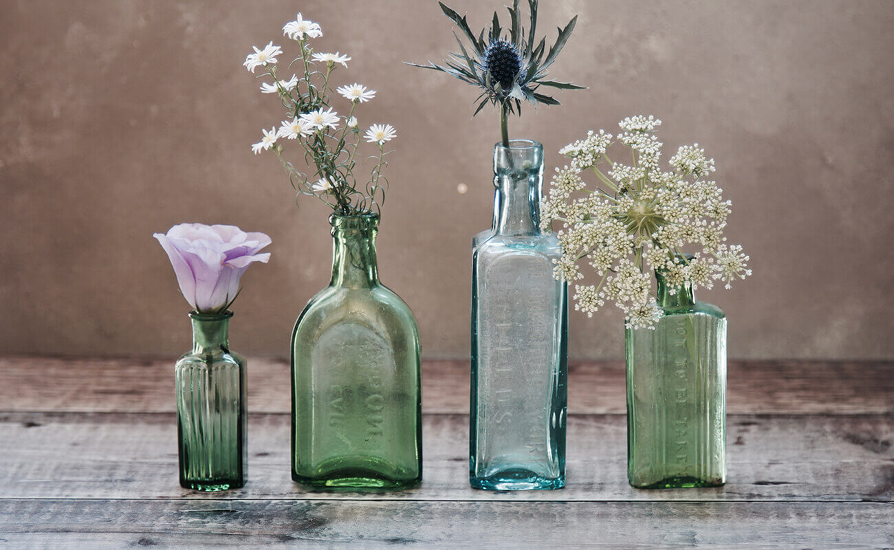 4 different flowers in their own vases