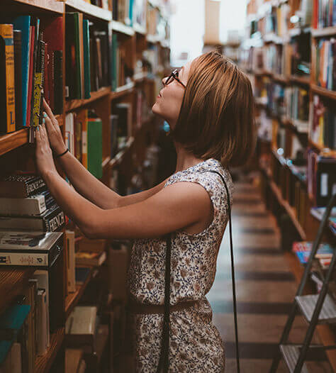 Person looking for books in a library