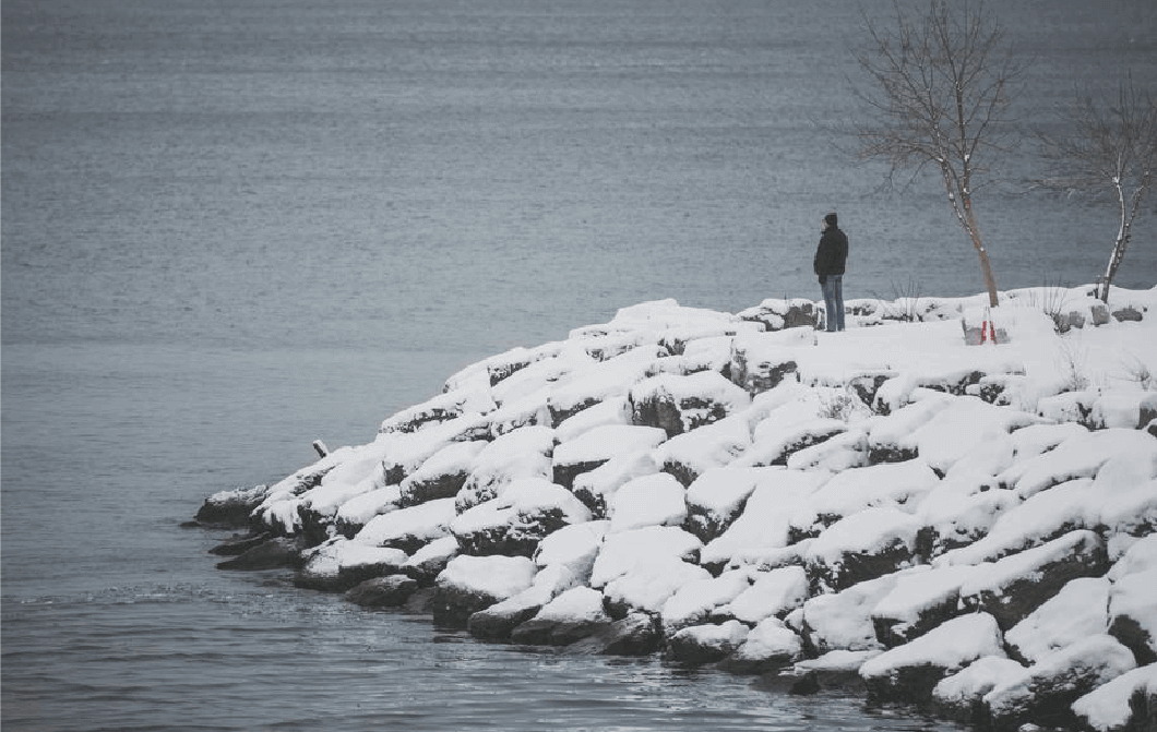 person standing in a snow-covered inlet