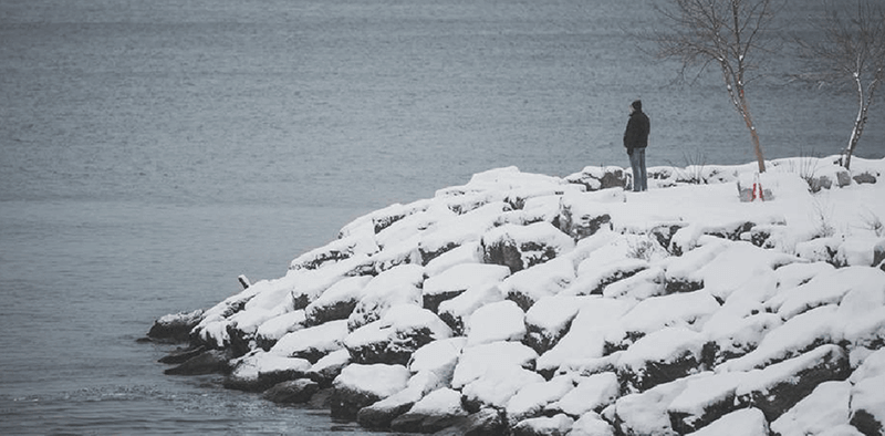 A person standing on a snow covered inlet