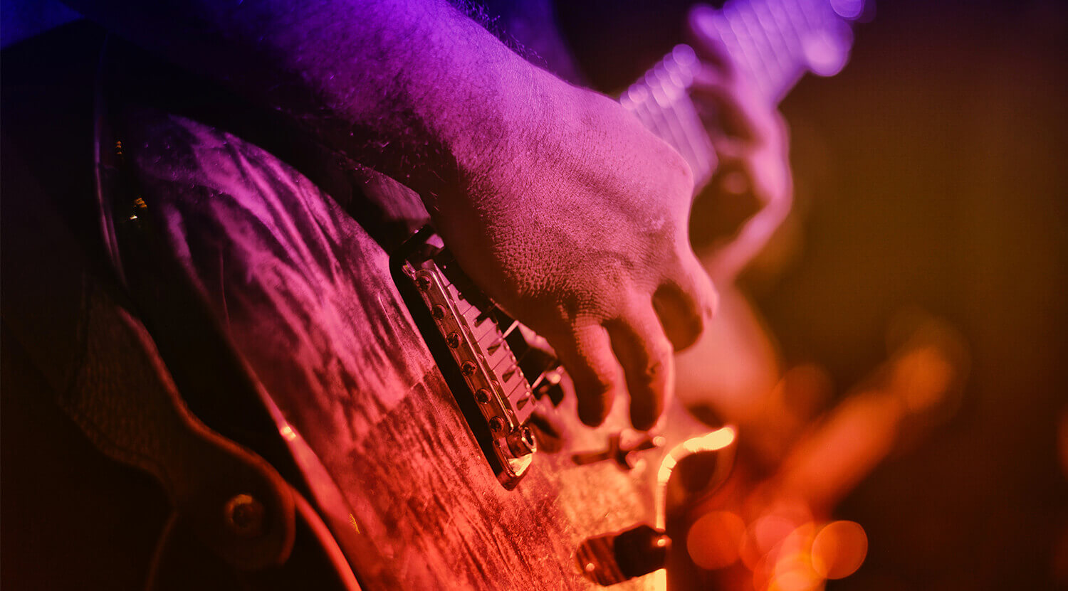Person strumming guitar
