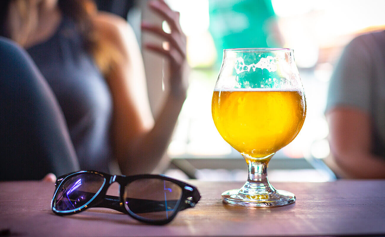 Shot of a wine glass and sunglasses