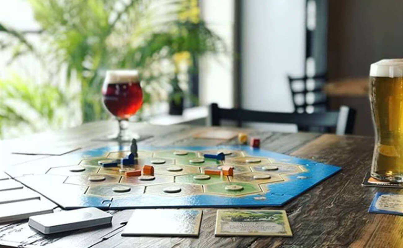 Wine and beer on a table with boardgames